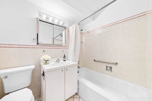 full bathroom with tile walls, vanity, shower / bath combination with curtain, tile patterned floors, and toilet