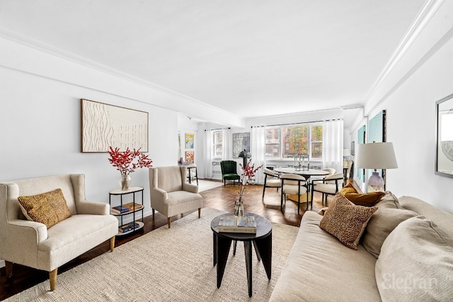 living room featuring hardwood / wood-style floors and crown molding