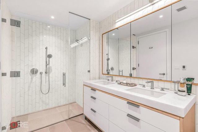 bathroom with vanity, tile walls, tile patterned floors, and a shower with door