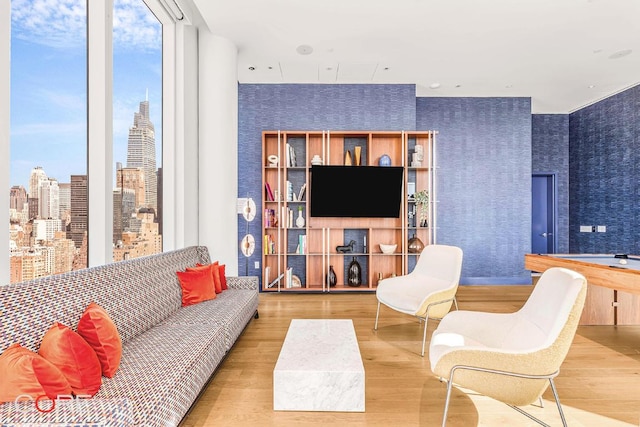 living room featuring floor to ceiling windows and hardwood / wood-style flooring