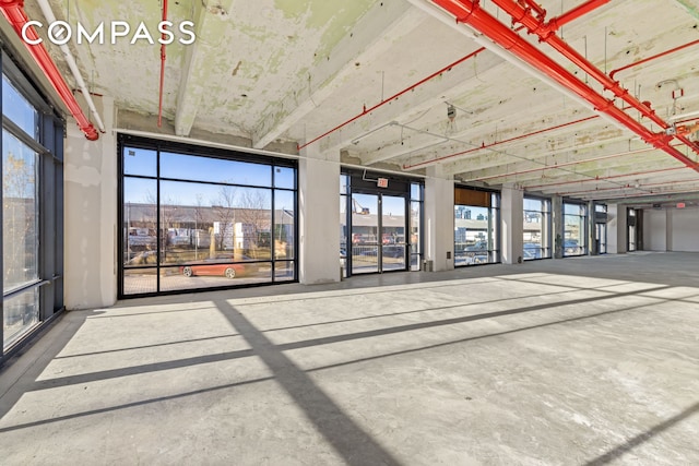 misc room with unfinished concrete floors and plenty of natural light