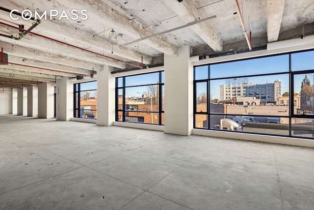 miscellaneous room with a view of city and concrete flooring