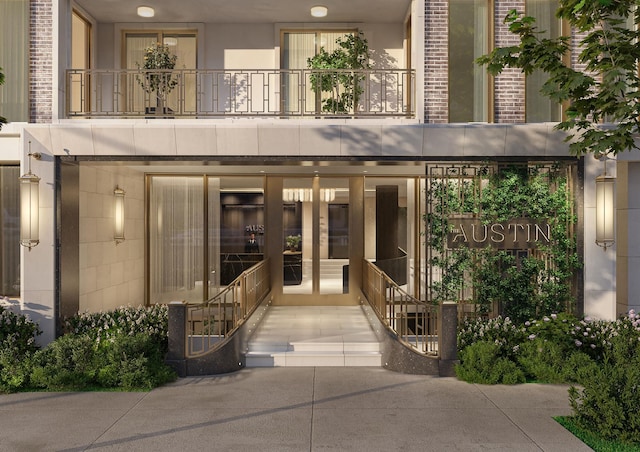 entrance to property with brick siding and a balcony