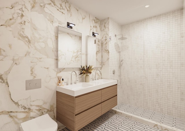 bathroom with double vanity, tiled shower, tile walls, and a sink