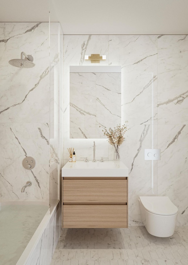 bathroom with toilet, vanity, and a combined bath / shower with marble appearance