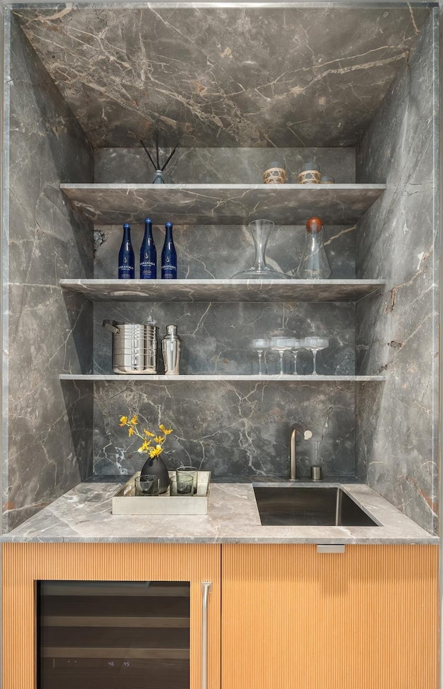 bar with wet bar, decorative backsplash, beverage cooler, and a sink