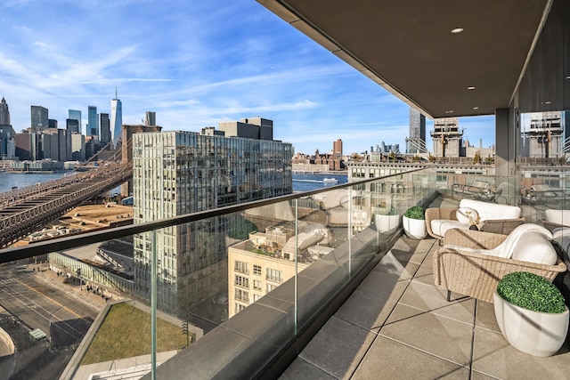 balcony featuring a view of city and a water view