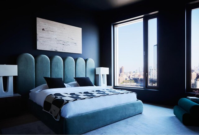 bedroom featuring a view of city and carpet floors