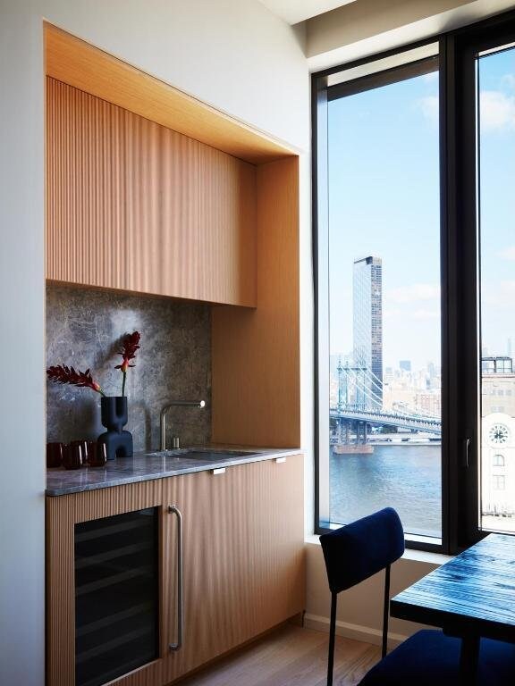 kitchen with a sink, decorative backsplash, wine cooler, a view of city, and modern cabinets