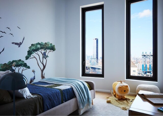 bedroom with baseboards, multiple windows, and wood finished floors