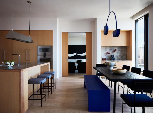 dining space with light wood-style flooring