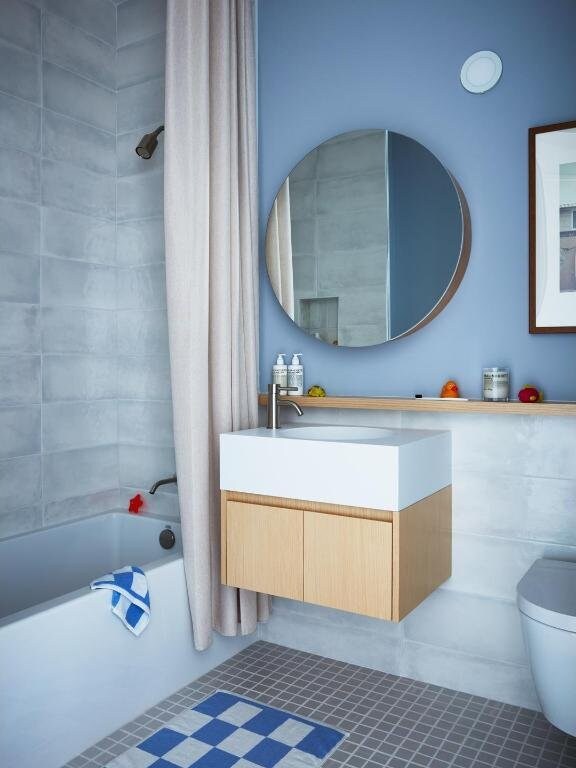 bathroom featuring vanity, tile patterned floors, shower / tub combo, and toilet