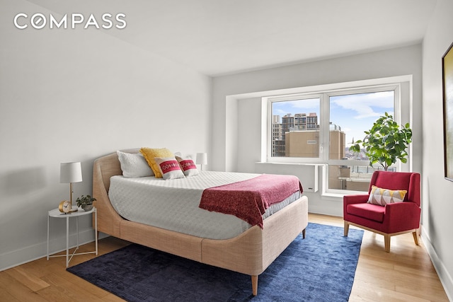 bedroom featuring wood finished floors and baseboards