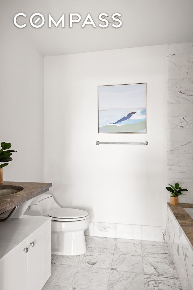 440 Kent Ave Unit 18F, New York City, NY 11249 - full bathroom with marble finish flooring, vanity, toilet, and tiled tub