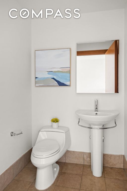 bathroom with tile patterned floors and toilet