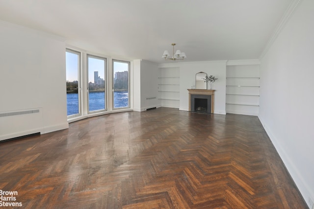 unfurnished living room featuring a notable chandelier, a fireplace, radiator heating unit, ornamental molding, and baseboards