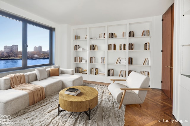 living area with a water view and a city view