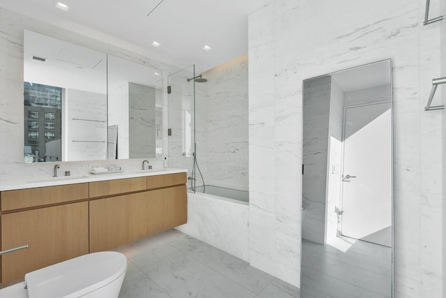 full bathroom featuring double vanity, marble finish flooring, a combined bath / shower with marble appearance, and toilet