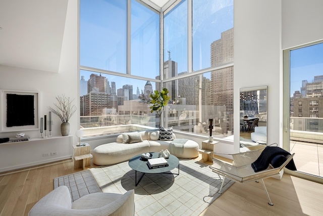 sunroom / solarium featuring a skyline view and healthy amount of natural light