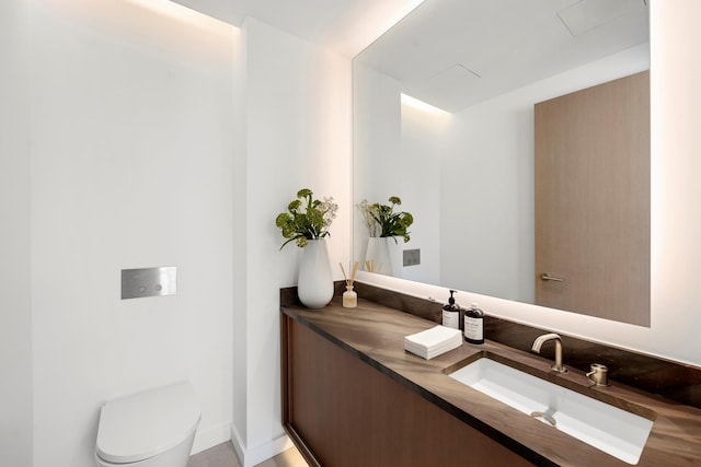 bathroom with toilet and vanity