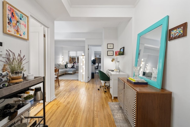 hall featuring crown molding and light hardwood / wood-style flooring