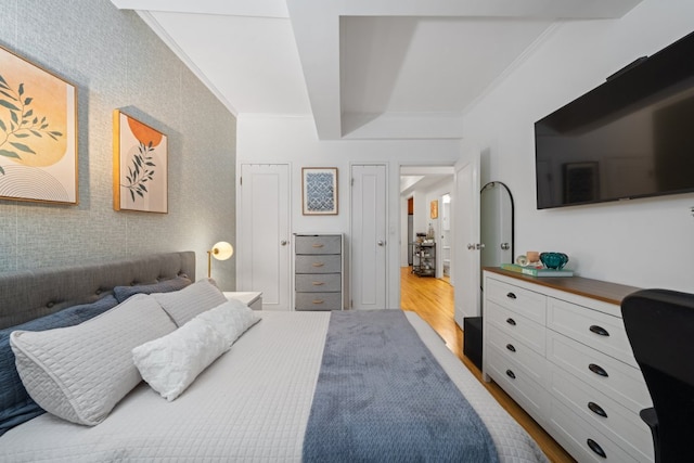 bedroom with hardwood / wood-style flooring and ornamental molding