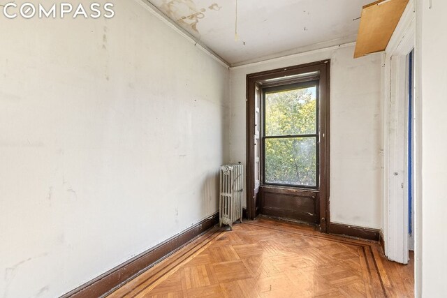 interior space featuring radiator and light parquet floors