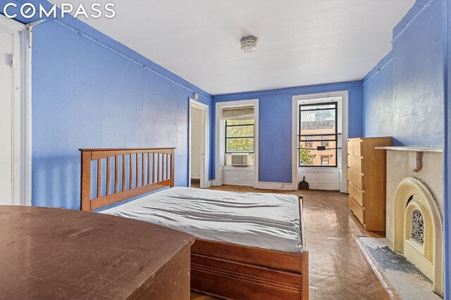 bedroom featuring cooling unit and parquet floors