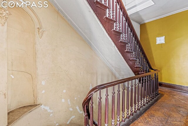 staircase featuring ornamental molding