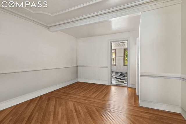 unfurnished room with crown molding