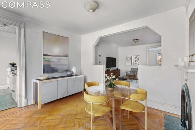 dining room featuring light parquet flooring and ornamental molding