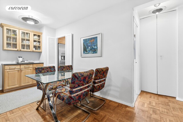 dining space featuring light parquet flooring