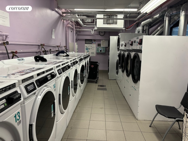 laundry room featuring washer and dryer and light tile patterned floors