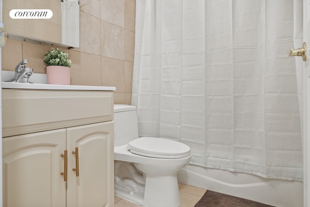 full bathroom featuring vanity, tile patterned flooring, toilet, and tile walls