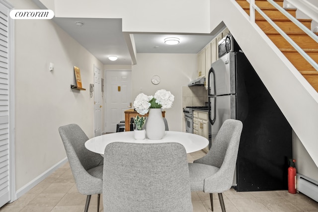 753 E 5th St Unit 4C, New York City, NY 10009 - dining room with light tile patterned floors, baseboard heating, and baseboards