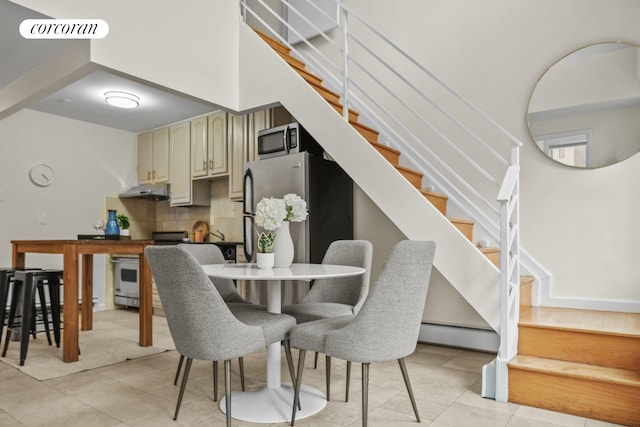 753 E 5th St Unit 4C, New York City, NY 10009 - dining space with stairs, baseboard heating, and light tile patterned flooring