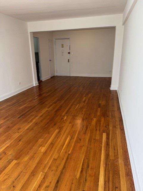 empty room featuring dark hardwood / wood-style flooring