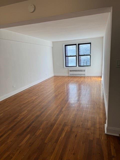 spare room with dark wood-type flooring