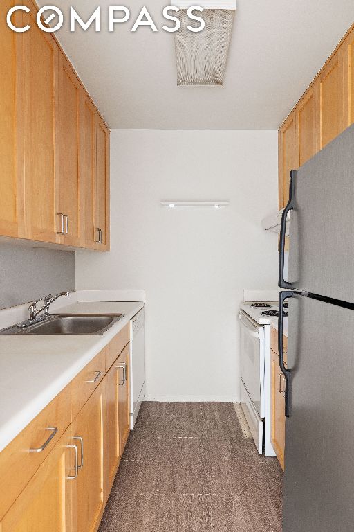 kitchen with sink and white appliances