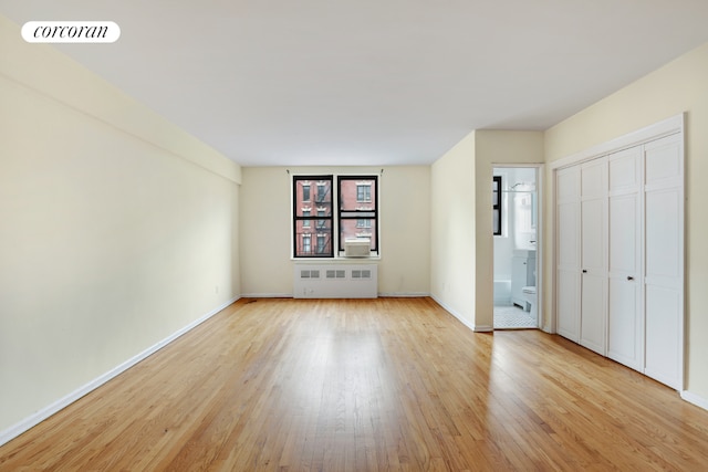 interior space with light hardwood / wood-style flooring and radiator