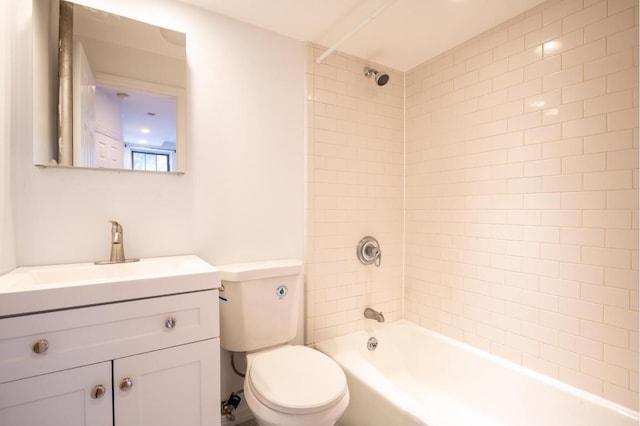 full bathroom with toilet, tiled shower / bath combo, and vanity