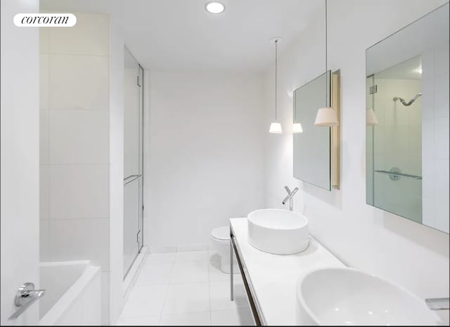 bathroom with a stall shower, toilet, double vanity, recessed lighting, and tile patterned floors