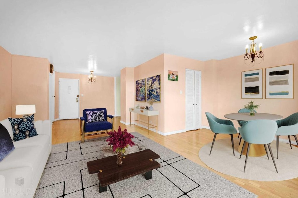 living room with an inviting chandelier and hardwood / wood-style flooring