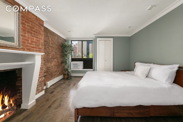 bedroom featuring a baseboard heating unit, ornamental molding, brick wall, a warm lit fireplace, and hardwood / wood-style flooring