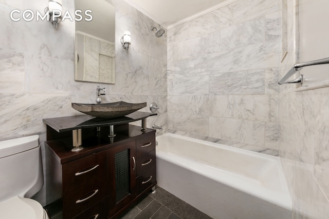 bathroom featuring shower / washtub combination, crown molding, tile walls, toilet, and vanity