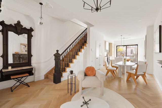 dining room featuring stairs, an inviting chandelier, and baseboards