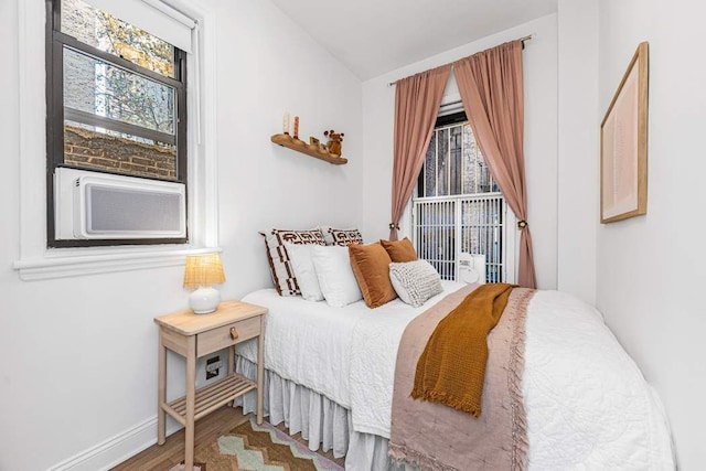 bedroom with wood-type flooring and cooling unit