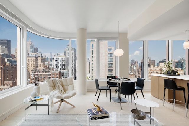sunroom / solarium featuring a view of city and a wealth of natural light