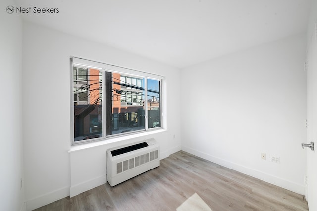 47-05 5th St Unit 203, New York City, NY 11101 - spare room featuring baseboards and wood finished floors