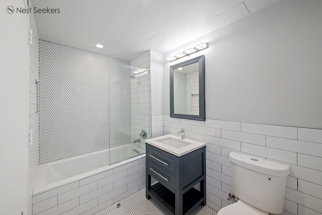 47-05 5th St Unit 203, New York City, NY 11101 - full bathroom featuring tiled shower / bath combo, vanity, tile patterned flooring, and tile walls